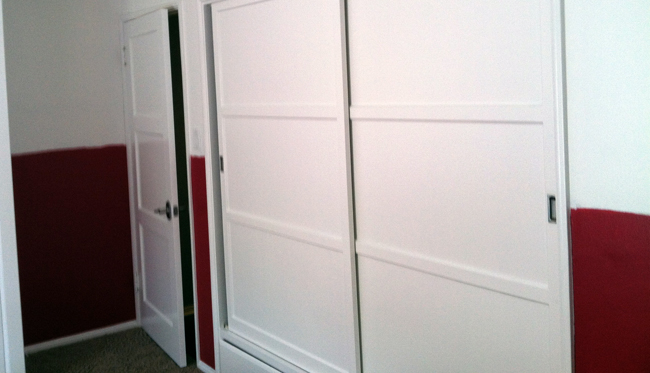 A handyman working on a door installation and repair
